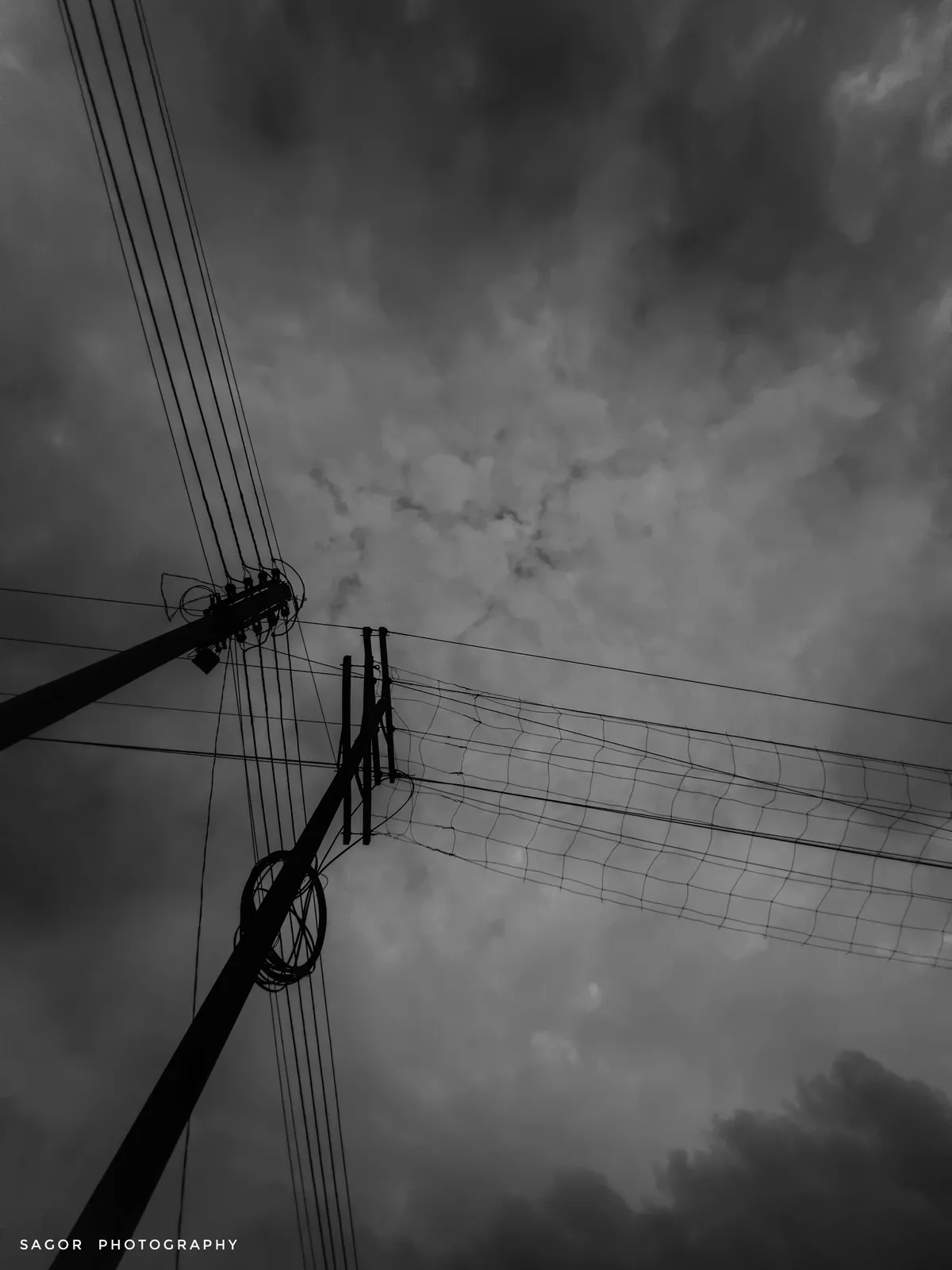 Lines: Wires and a grey sky, drawn like a pencil sketch.
