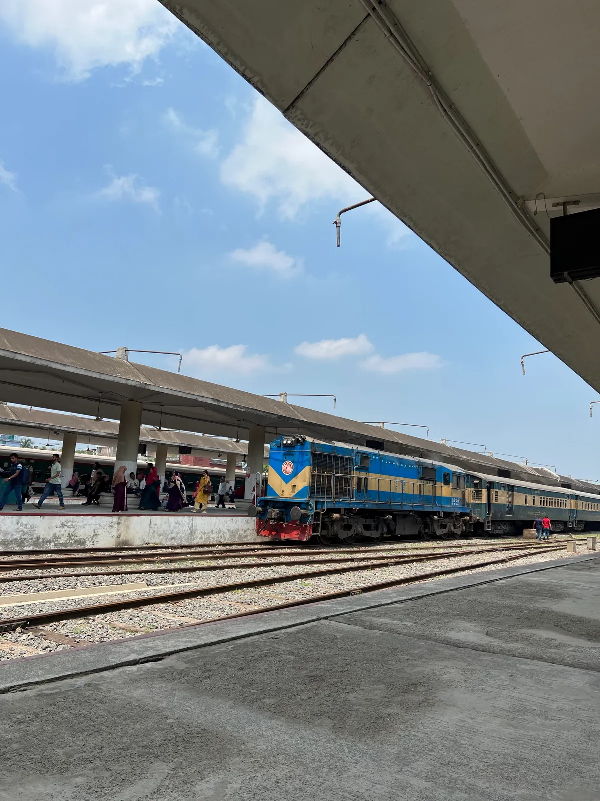 Platform: A train at the platform, the sky wide and blue.